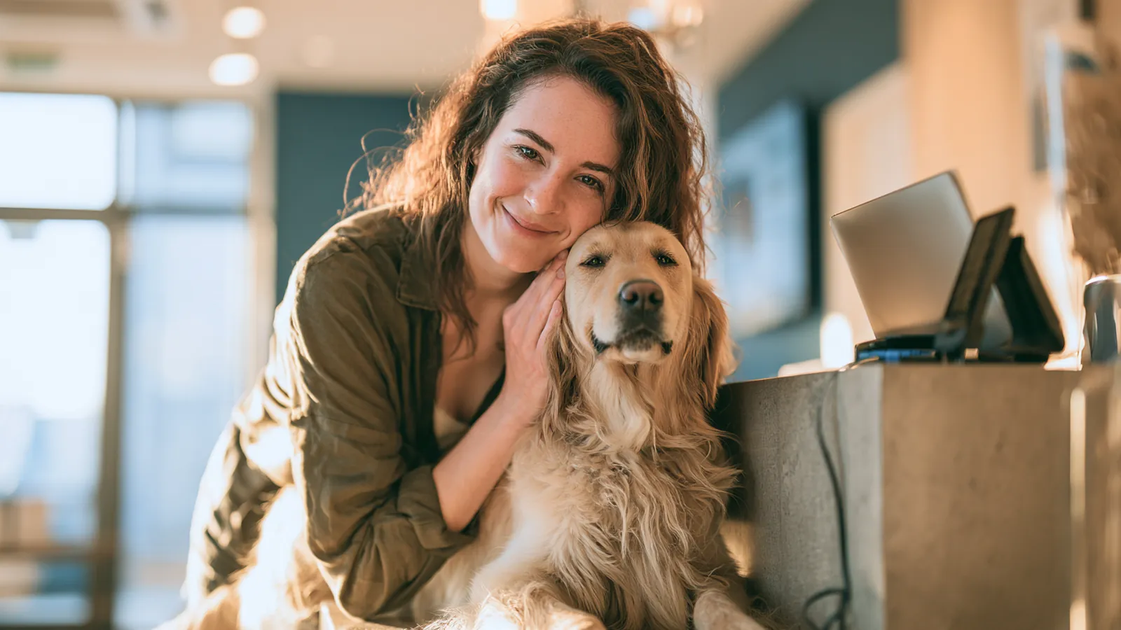 Woman comforting her golden retriever at a veterinary clinic visit covered by a 3000 dollar loan
