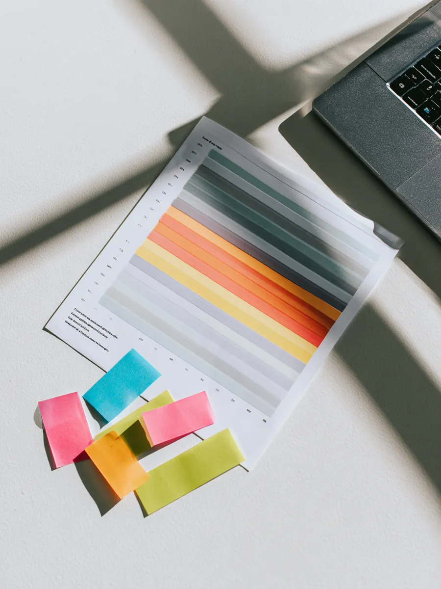 Printed credit score range chart with one band highlighted and sticky flags along the edge